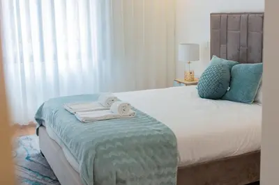 a bedroom with a bed with towels on it at Stunning Apartment w/ Free Parking by LovelyStay in Porto