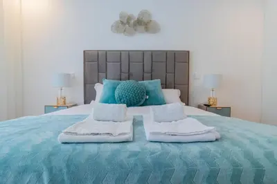a bedroom with a blue bed with towels on it at Stunning Apartment w/ Free Parking by LovelyStay in Porto