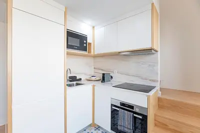 a small kitchen with a counter and a sink at Urban House by LovelyStay in Porto