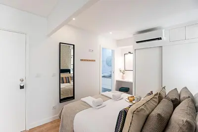 a bedroom with a large bed with a blue wall at Urban House by LovelyStay in Porto