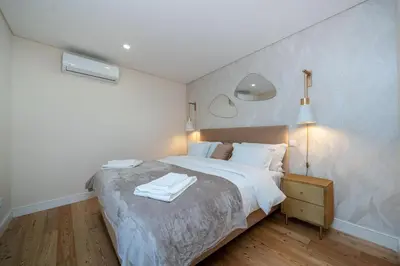 a bedroom with a bed with two towels on it at Formosa Apartments by Amber Star Rent in Porto