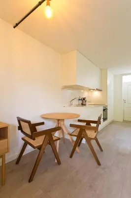 a kitchen with a table and two chairs in a room at Zen Garden Studio C in Porto