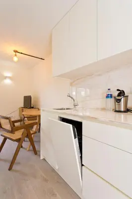 a bedroom with a large bed and a chair at Zen Garden Studio C in Porto