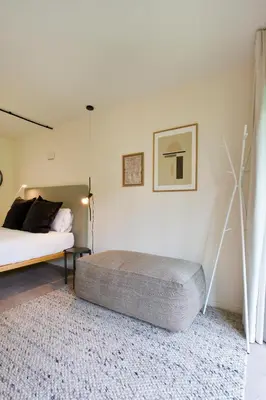 a large white bed in a room with a kitchen at Zen Garden Studio C in Porto