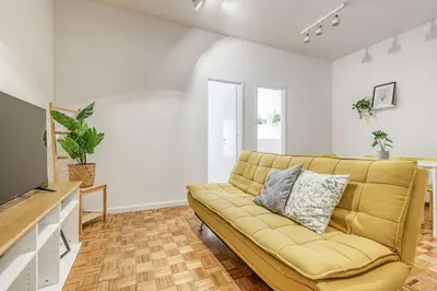 a living room with a couch and a television at Travel & Live Alegria 248 in Porto