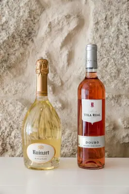 a bottle of whisky sitting on a table next to a bottle of alcohol at OPO Bonjardim 902 I in Porto