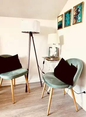 two chairs and a lamp in a room at LUXURY PENTHOUSE - River Gallery Art - View&Center in Vila Nova de Gaia