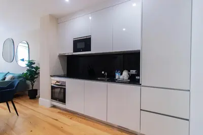 a living room with a large white cabinet with a tv at Almada 1.3 by LovelyStay in Porto
