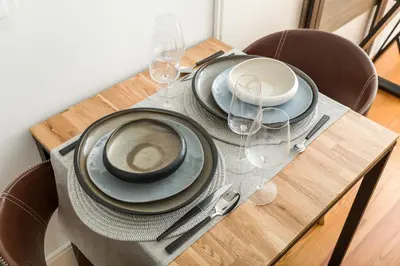 a table with plates and wine glasses on it at OPO Alegria 119 in Porto