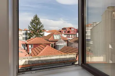 a view from a window of roofs at OPO Alegria 119 in Porto