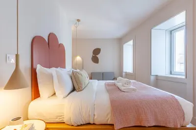 a bedroom with a large white bed with white pillows at D&S - JB Apartments in Porto