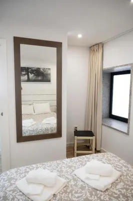 a bedroom with a large mirror and a bed at Oporto Mi House in Porto