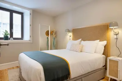 a bedroom with a large bed and a window at Away to Discover Apartment - hapiness has a place in Porto