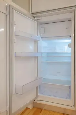 an empty refrigerator with its door open with its door open at Away to Discover Apartment - hapiness has a place in Porto