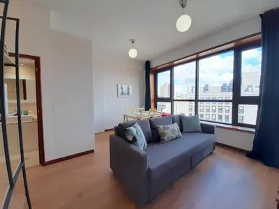 a living room with a couch and a large window at Porto Vista II by Flat in Porto in Porto