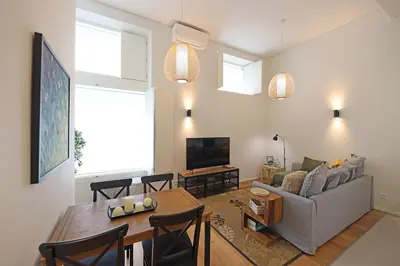 a living room with a table and a couch at FLH Gaia Homey Winery Flat in Vila Nova de Gaia