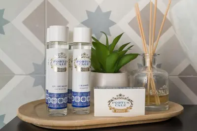 a shelf with three bottles of soap and a bottle of oil at Apartments2Stay I Porto - Flores in Porto