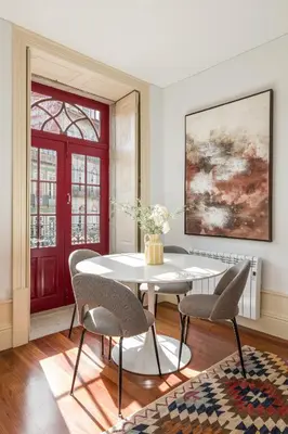 a dining room with a table and chairs and a red door at Apartments2Stay I Porto - Flores in Porto