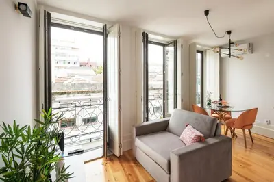a living room with a couch and a table at Bright Studio near Douro River - with Balcony in Porto