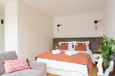 a bedroom with a bed and a couch at Bright Studio near Douro River - with Balcony in Porto