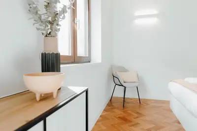 a bedroom with a table with a vase on it at JARS Apartments - Casa do Bessa in Porto