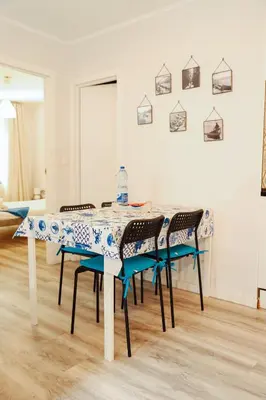 a dining room table with four chairs and a table at Sailor's House 2 - Holiday's House in Porto