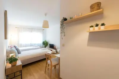 a living room with a laptop computer on a desk at Boavista Boho Apartment w/ Garage in Porto