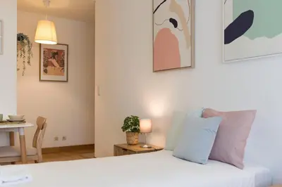 a living room with two beds and a couch at Boavista Boho Apartment w/ Garage in Porto