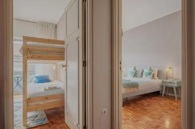 a bedroom with a bed and a bunk bed at Sunny and Spacious House, 4BD 3Bath Downtown Porto in Porto