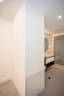 a bathroom with white walls and a glass door at Liiiving in Porto - Ribeira Riverside Apartment in Porto