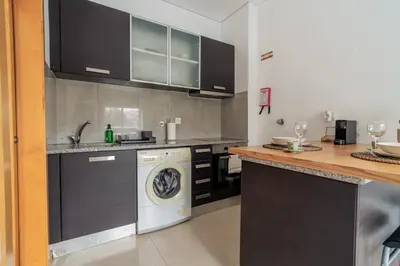 a kitchen with a sink and a dishwasher at Mauve Studio perto do Metro, Cedofeita, Porto in Porto