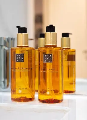 three bottles of soap sitting on a counter at Strelitzia Apartment, by Bolhão Residences in Porto