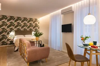a hotel room with a bed and a table at Strelitzia Apartment, by Bolhão Residences in Porto