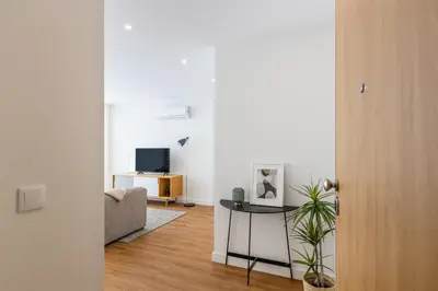 a living room with a table and a couch at Pestana Apartments - Premium in Porto