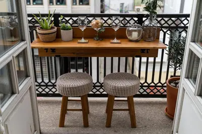 a table with two chairs and glasses on a balcony at Porto Contemporary Apartment in city center in Porto