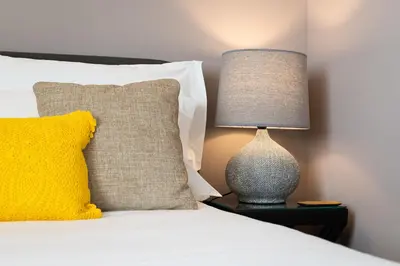 a bed with a yellow pillow and a lamp on a table at Lemon Mezzanine - Santa Catarina in Porto