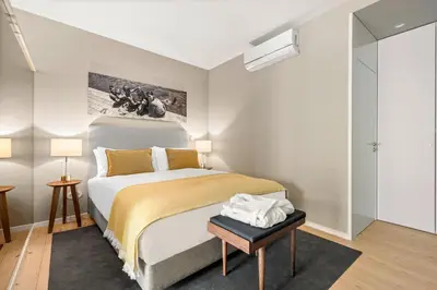 a bedroom with a bed and a table in a room at 108MM House in Porto