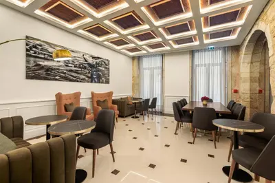 a waiting room with tables and chairs and a ceiling at 108MM House in Porto