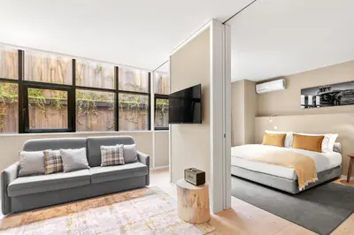 a bedroom with a bed and a couch at 108MM House in Porto