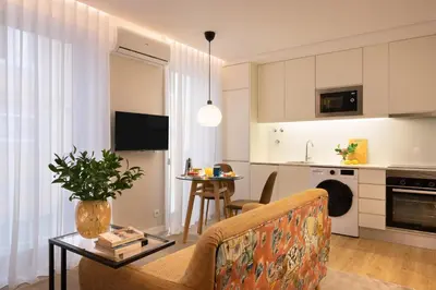 a living room with a couch and a table at Wanderlust, by Bolhão Residences in Porto