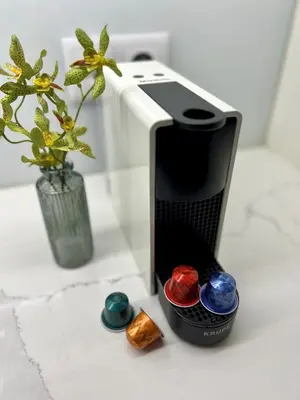 a toaster sitting on a counter next to a vase with flowers at Wanderlust, by Bolhão Residences in Porto