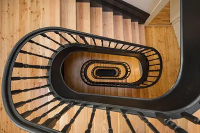 a spiral staircase with a black metal railing at Ribeira apartment 6M- vista fabulosa in Porto