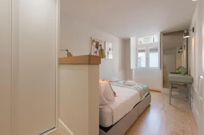 a small bedroom with a bed and a shower at Porta do sol Luxury Apartment in Porto