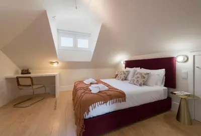 a bedroom with a large bed in a attic at Porta do sol Luxury Apartment in Porto