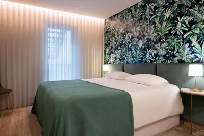 a bedroom with a large bed with a floral wall at Byobu Apartment, by Bolhão Residences in Porto