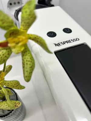 a white electric phone sitting next to a plant at Byobu Apartment, by Bolhão Residences in Porto