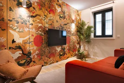 a living room with a tv on a wall at Byobu Apartment, by Bolhão Residences in Porto