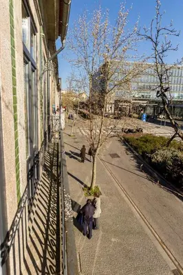 a group of people standing on a sidewalk next to a building at Oporto Modern Apartments - Campanha Train Station in Porto