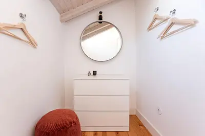 a dressing room with a mirror and a white dresser at D. João IV Apartments by LovelyStay in Porto