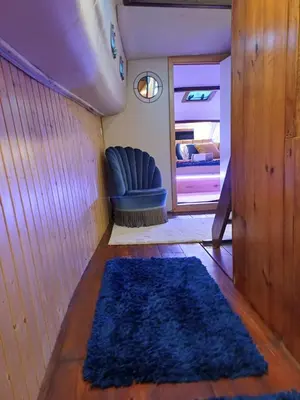 a living room with a blue rug on the floor at SLEEPBOAT LuxLife Yatch in Porto